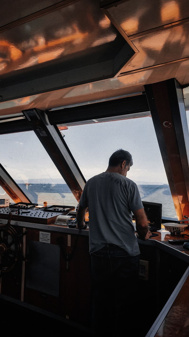 Master at the bridge console of a vessel at sea