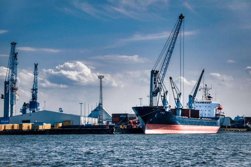 General cargo vessel working cargo alongside at a port