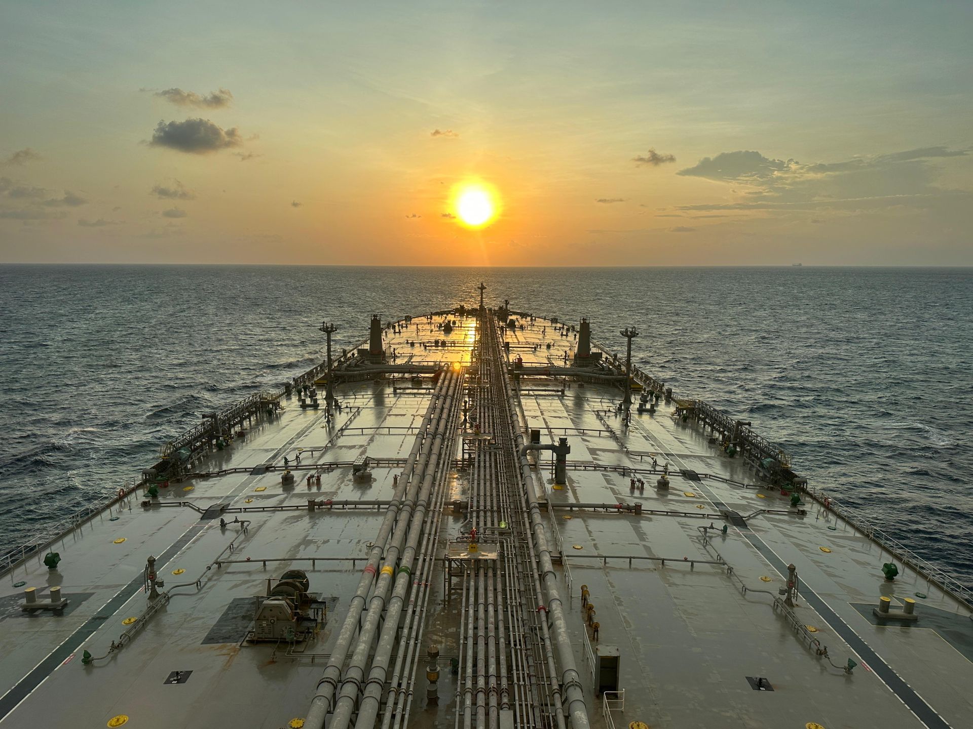 Main deck and cargo manifold of an oil tanker at sunset